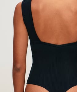 Ribbed cotton backless bodysuit with built-in pads;