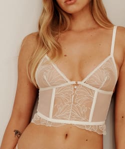 Mesh corset with floral embroidery and pearl pendant;