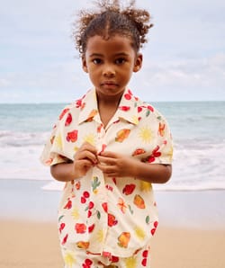 Short-sleeved shirt and patterned fruit and flower shorts;