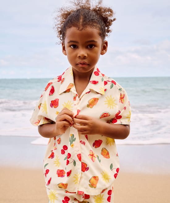 Short-sleeved shirt and patterned fruit and flower shorts;