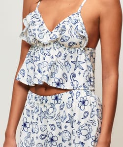 Satin crop top with V-neck, thin straps, and ruffles;