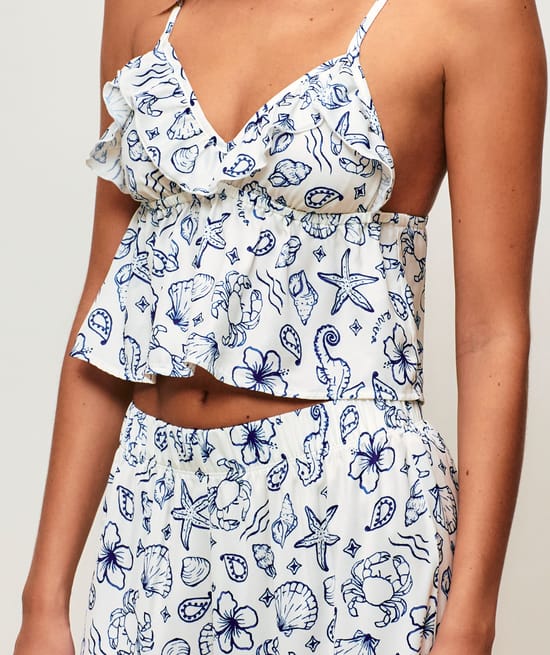 Satin crop top with V-neck, thin straps, and ruffles;