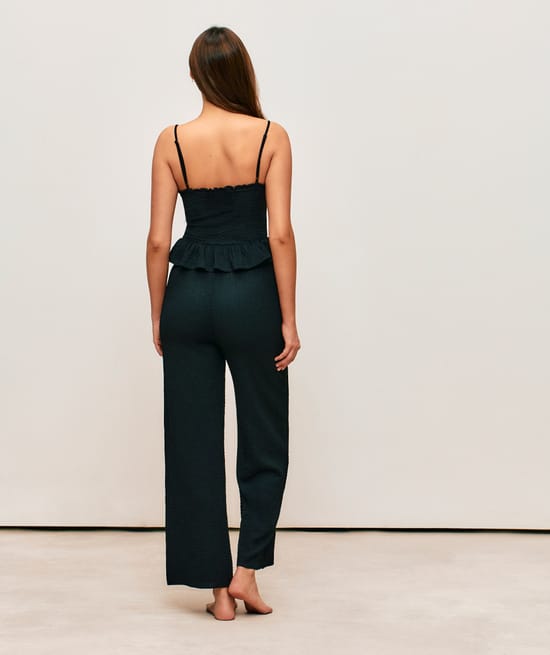 Black textured fabric pants;