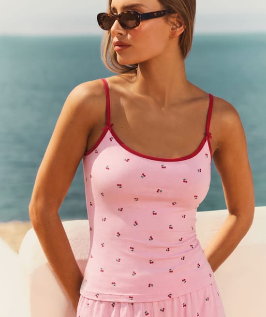Tank top with adjustable straps featuring a cherry pattern;