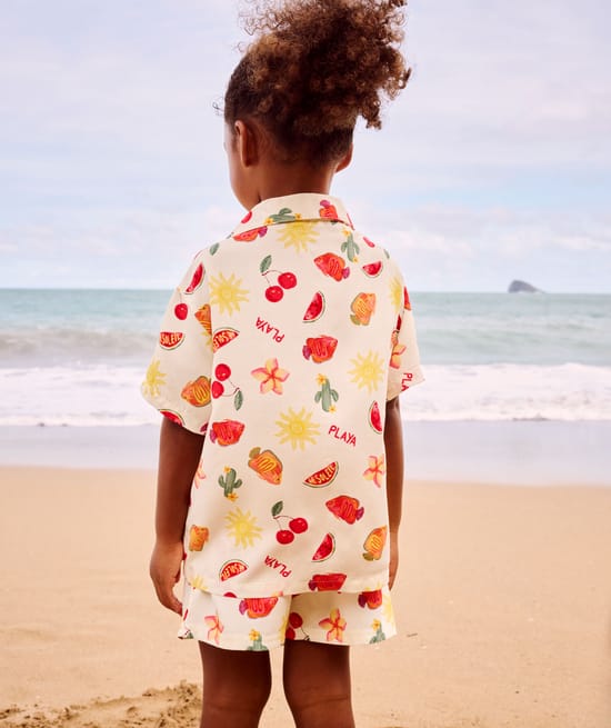 Short-sleeved shirt and patterned fruit and flower shorts;