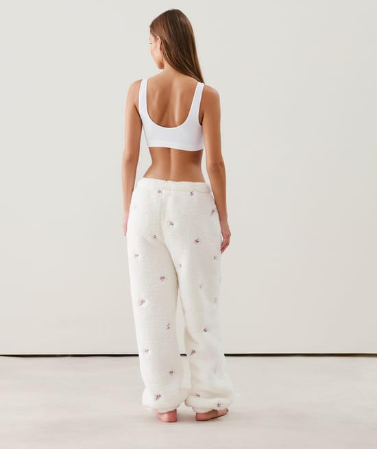 Fleece trousers with embroidered floral patterns;