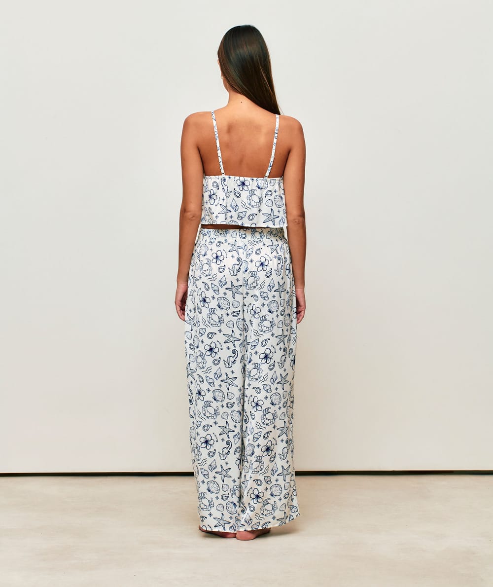 Satin crop top with V-neck, thin straps, and ruffles;