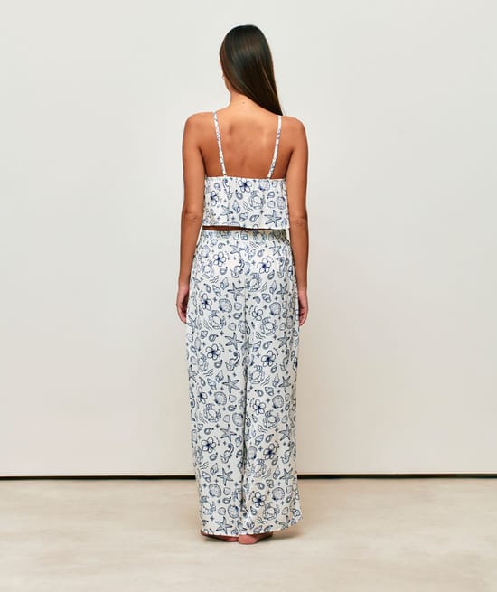 Satin crop top with V-neck, thin straps, and ruffles;