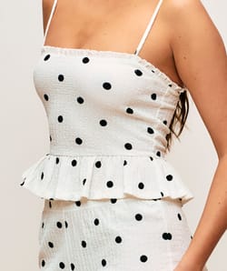 Textured fabric trousers with polka dot pattern;