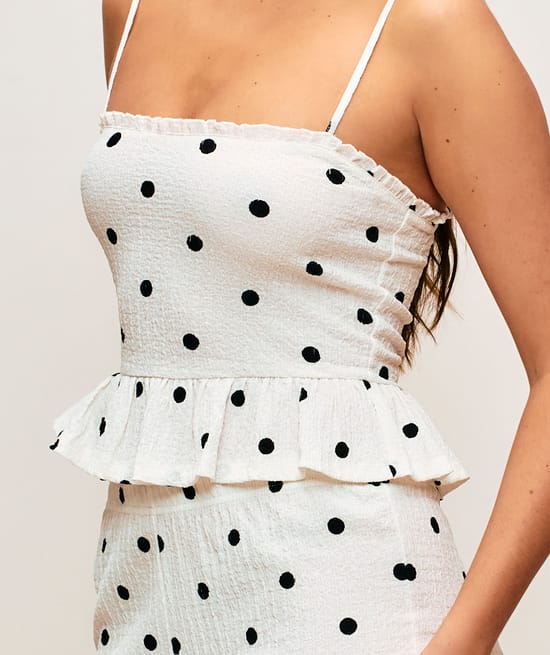 Textured fabric trousers with polka dot pattern;