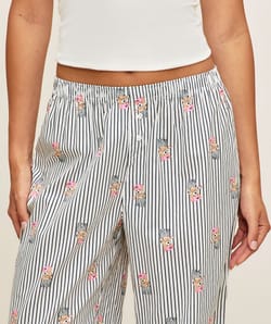 Striped trousers with bear print;