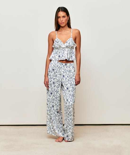 Satin crop top with V-neck, thin straps, and ruffles;