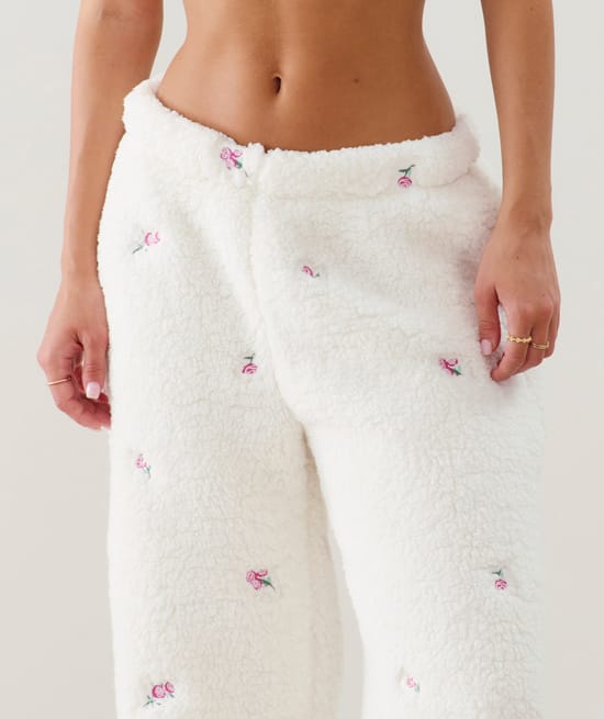 Fleece trousers with embroidered floral patterns;