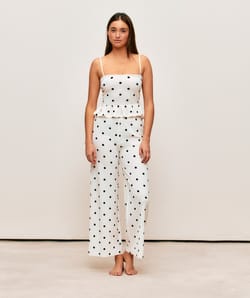 Textured fabric trousers with polka dot pattern;