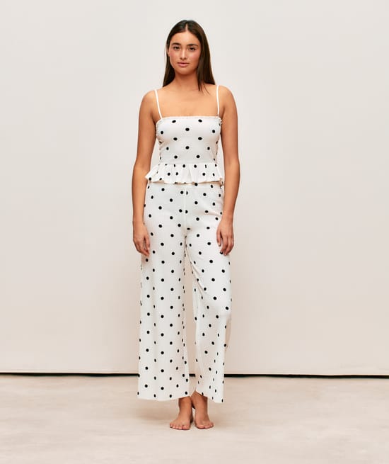 Textured fabric trousers with polka dot pattern;