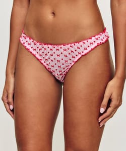 Mesh thong with heart and bow patterns;