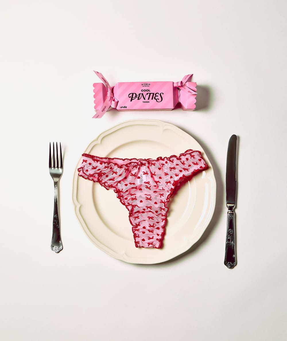 Mesh thong with heart and bow patterns;