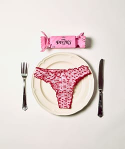 Mesh thong with heart and bow patterns;