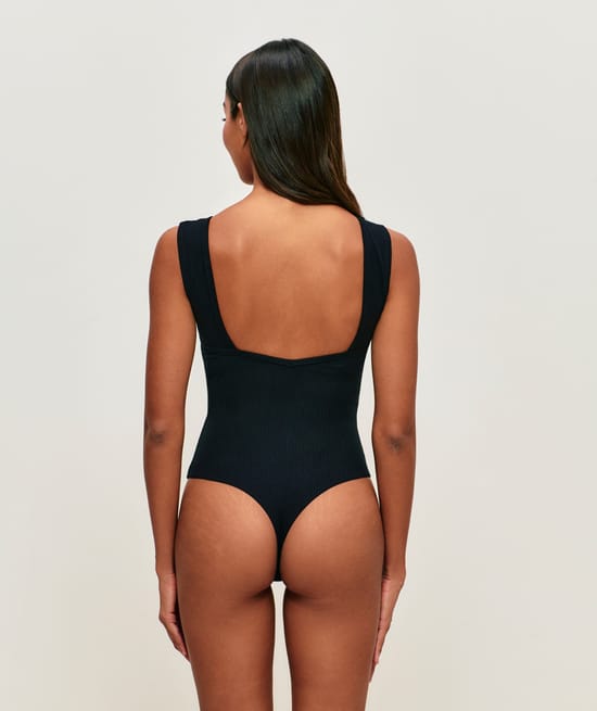 Ribbed cotton backless bodysuit with built-in pads;