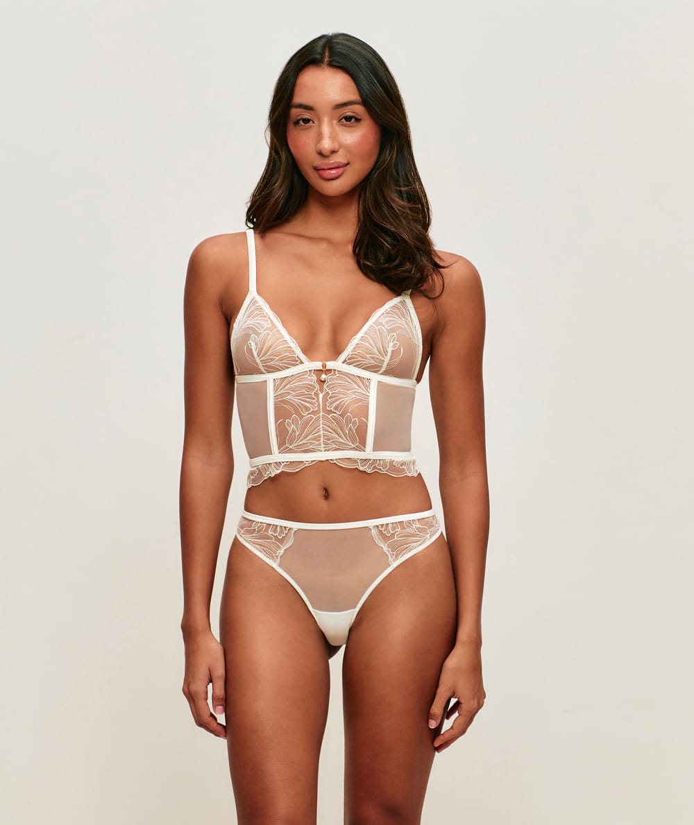 Mesh corset with floral embroidery and pearl pendant;