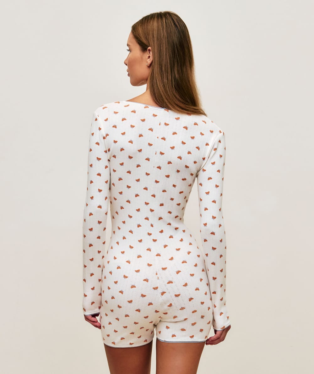Long sleeve jersey playsuit with crescent patterns;