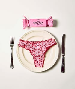 Mesh thong with heart and bow patterns;