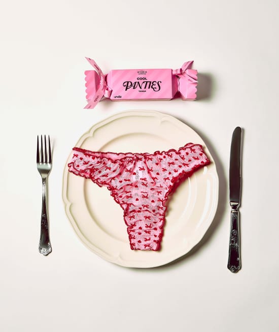 Mesh thong with heart and bow patterns;