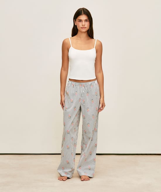 Striped trousers with bear print;