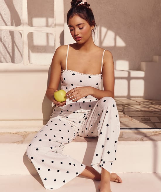 Textured fabric trousers with polka dot pattern;