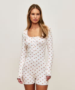 Long sleeve jersey playsuit with crescent patterns;