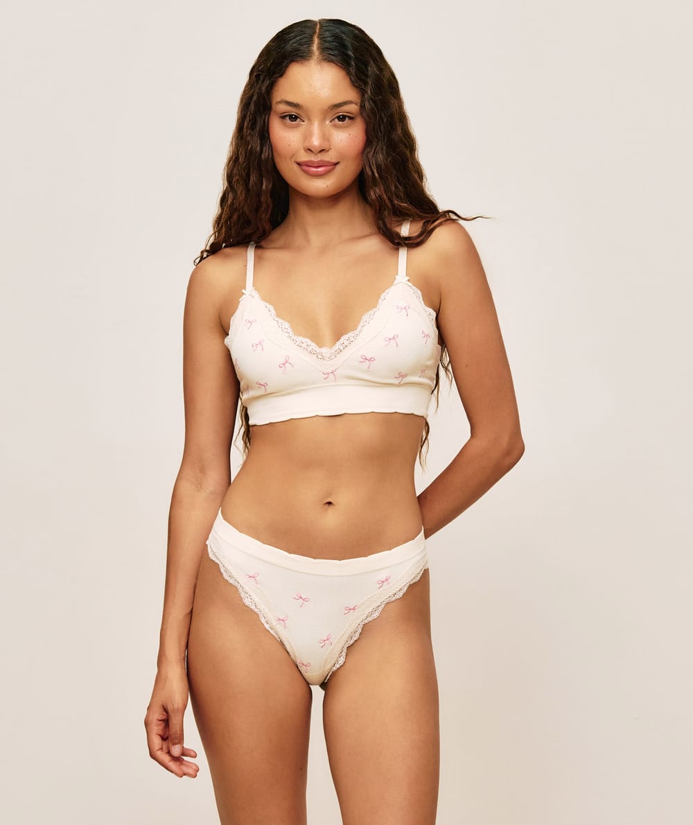 Seamless thong with embroidered lace bows;