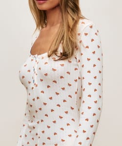 Long sleeve jersey playsuit with crescent patterns;