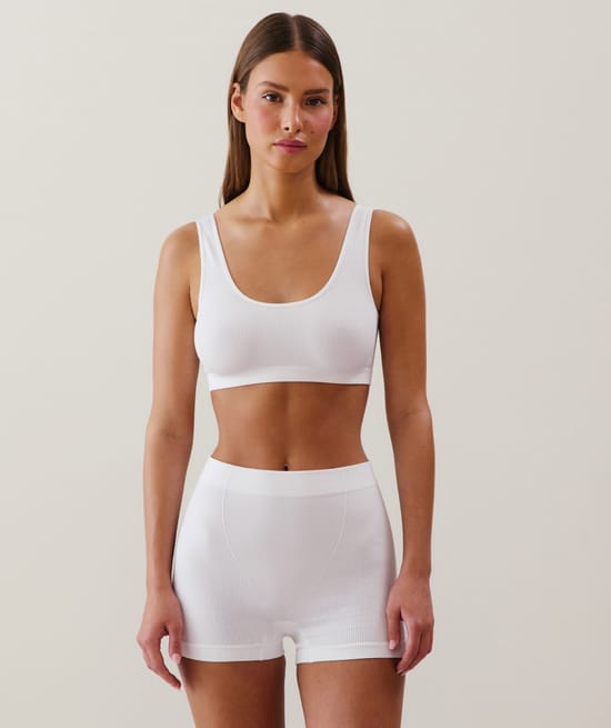 Ribbed seamless bralette in white;