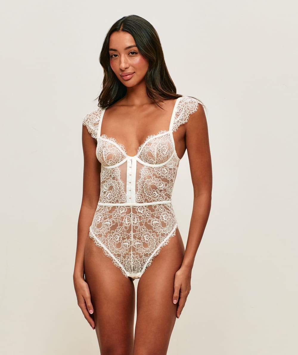 Lace backless bodysuit with shoulder pads;