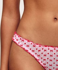 Mesh thong with heart and bow patterns;